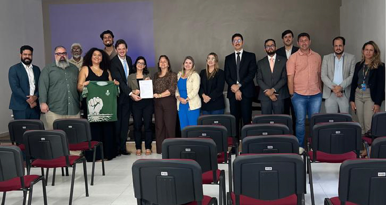 Imagem dos participantes da reunião posando para a foto em pé e lado a lado
